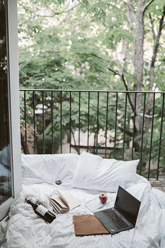 Freelancing working with book and bottle of wine